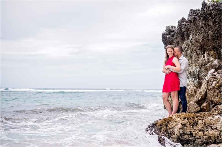 Girl In Red Dress on rocks at beach for engagement session