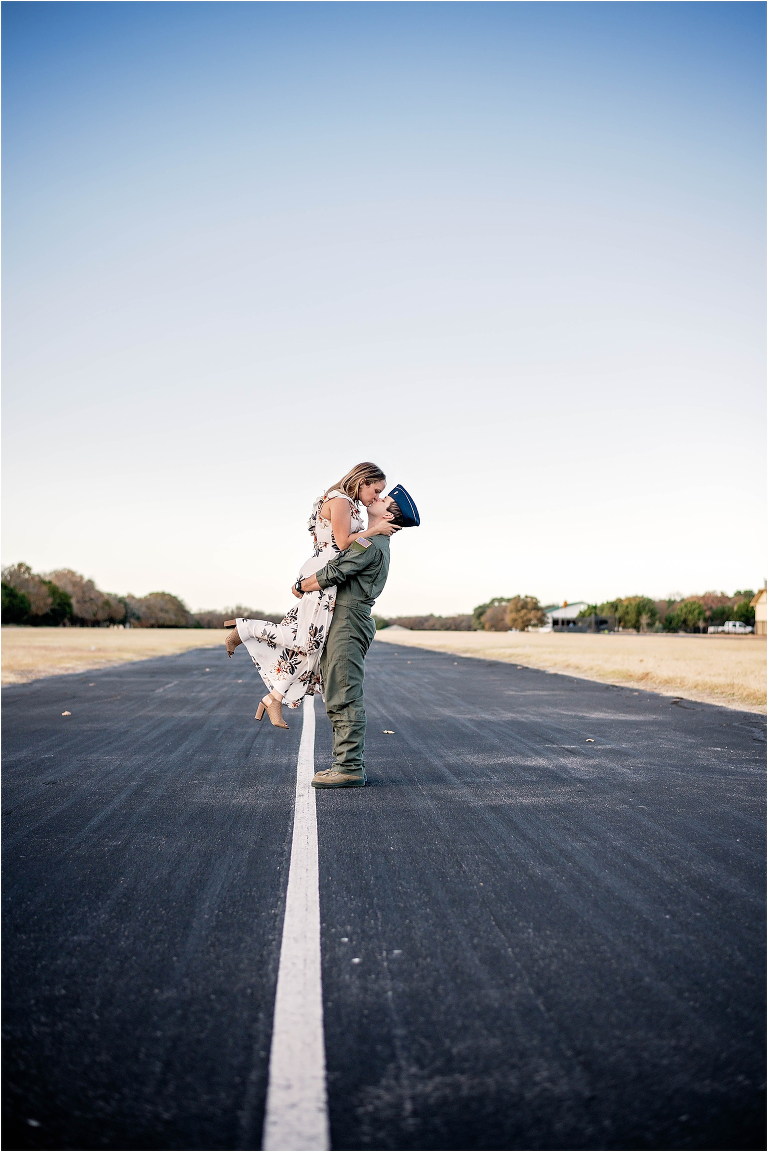 Air Force Engagement Photoshoot with Couple Kissing on Airport Runway