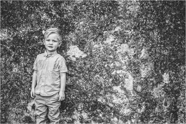 Little boy leaning against wall in Austin Texas Family Photoshoot by Natural Light Children Photographer