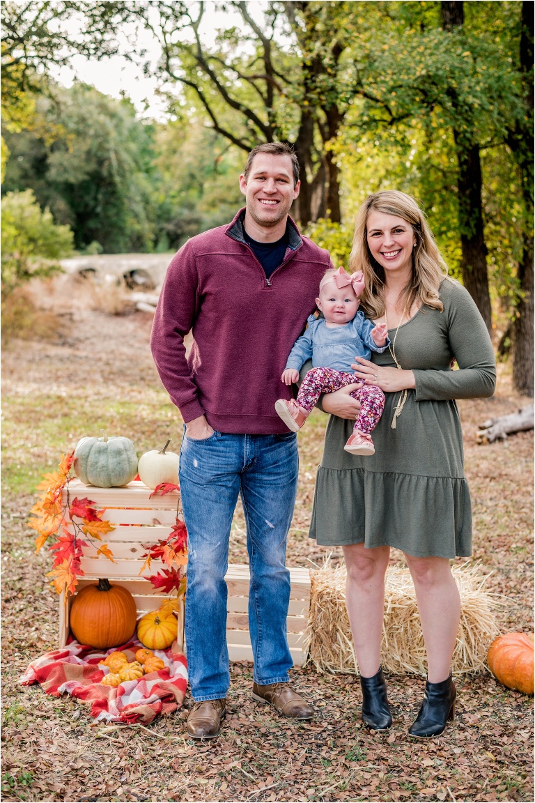 mother and father with little girl during Fall Mini Photoshoot in Cedar Park Texas by natural light family photographer located in Austin TX