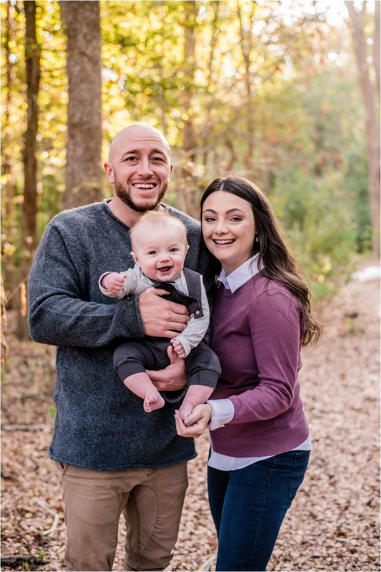 Family of three in Round Rock Texas Parents with little six month old boy fall holiday photos by natural light photographer