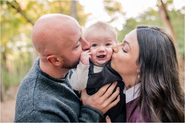 Family of three in Round Rock Texas Parents with little six month old boy fall holiday photos by natural light photographer