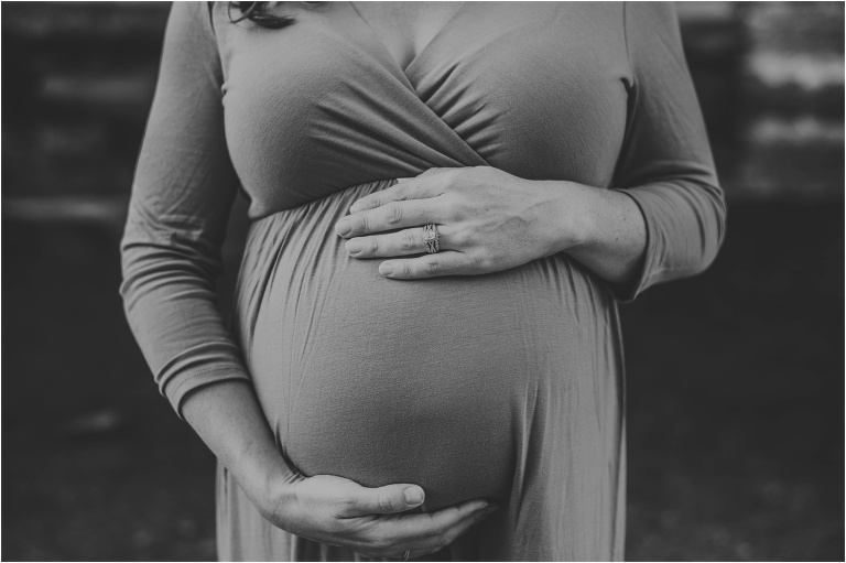 expecting mother with hands on belly in austin texas during maternity photoshoot