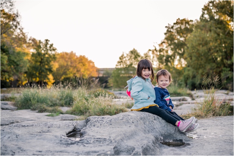 Sisters snuggling together during family photoshoot in Round Rock Texas by natural light children photographer