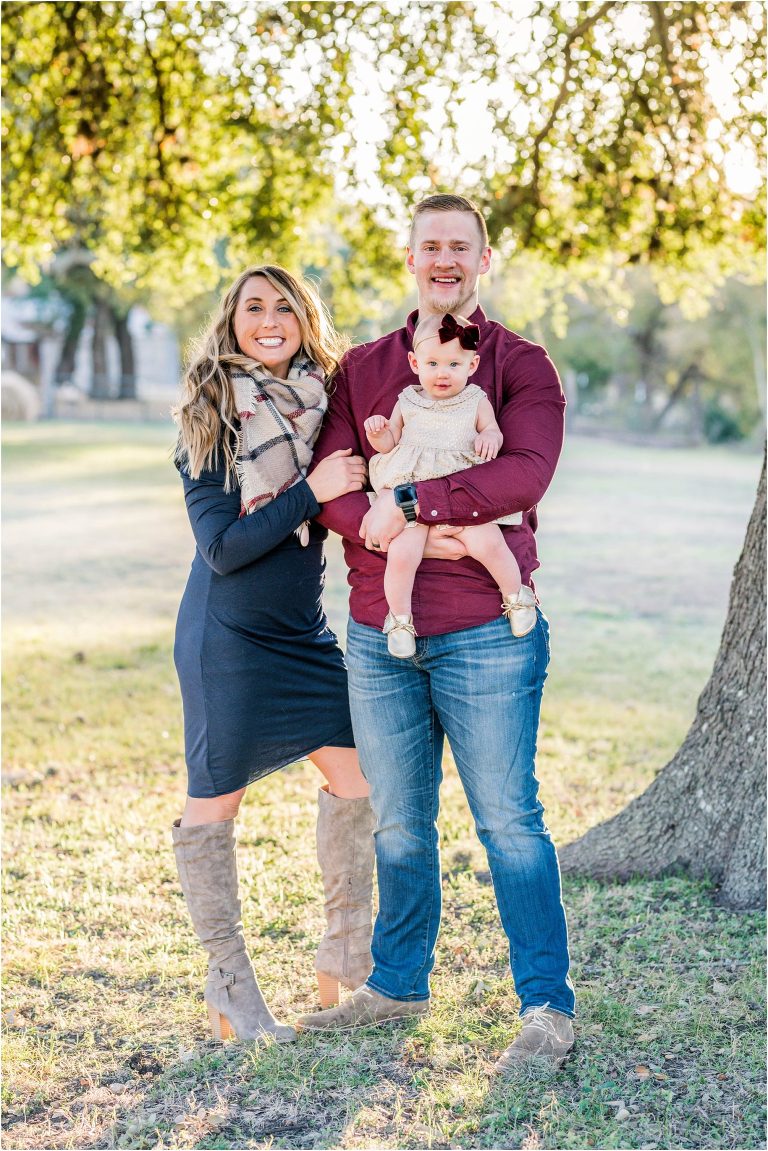 Family of three during Christmas photoshoot in Round Rock Texas by natural light portrait photographer