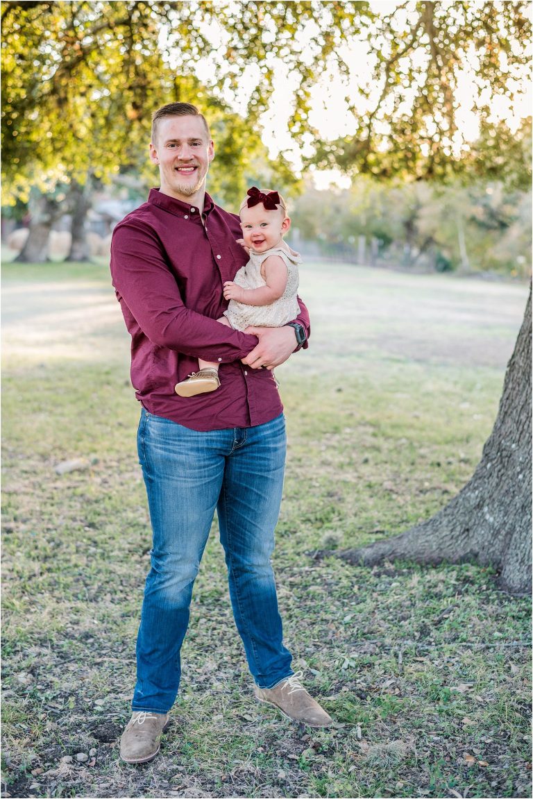 Father and toddler daughter snuggled together during family christmas photoshoot in Round Rock Texas