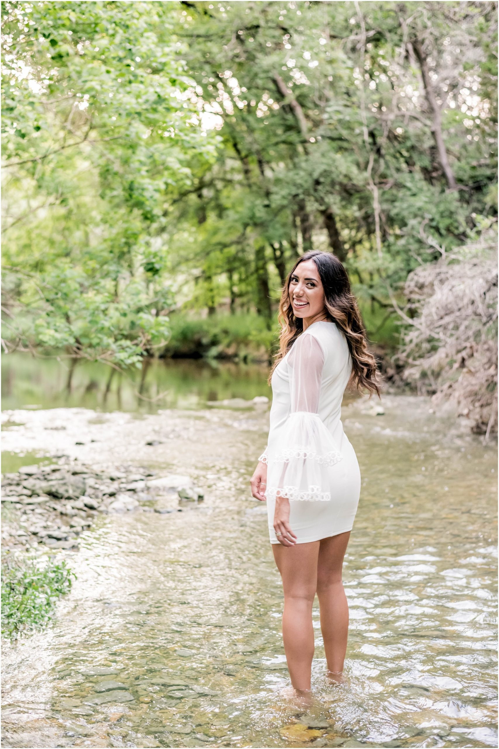 Senior Portrait Photoshoot with Girl in lace white dress standing in creek at Cedar Park Texas Natural Light Photographer