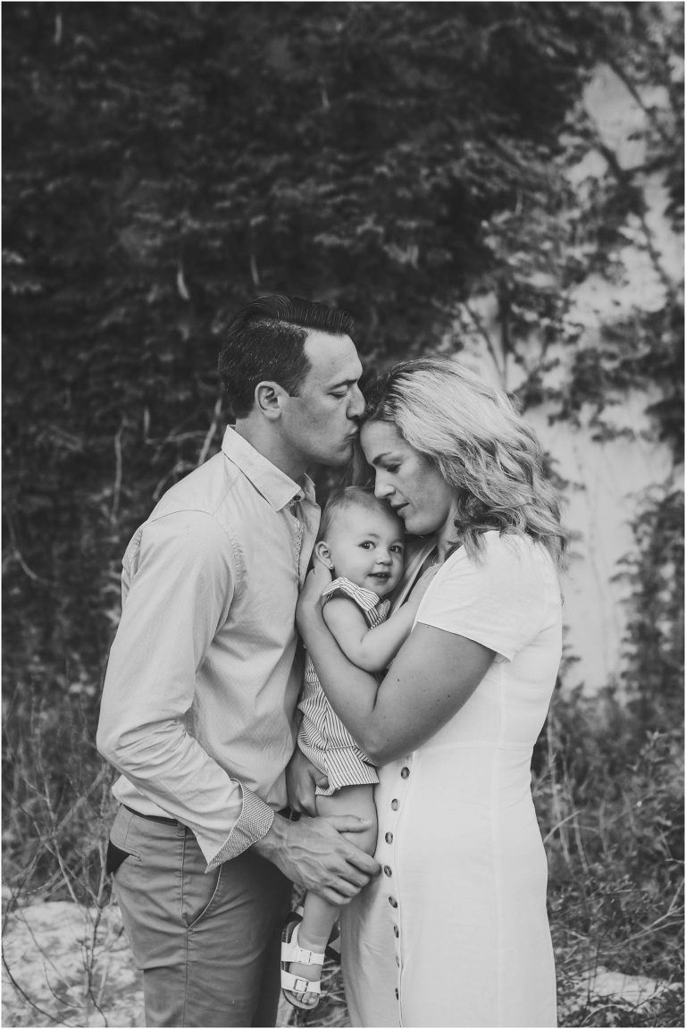 family snuggled up during photoshoot in Georgetown Texas by natural light portrait photographer during first birthday photo session